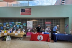 Red table is Delaware Relay - Feta Fernsler, blue table is Delaware Association of the Deaf - Keith Robertson, yellow table on left side is raffle table