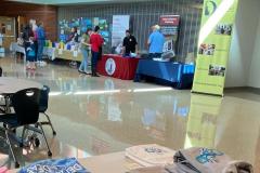 Hallway tables showing Delaware ASsociation of the Deaf, Delaware Relay and raffle table