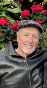 Jay Innes in a leather biker jacket with a riding hat