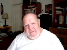 George Delinois identifies as white with a white beard and wearing a white shirt, 