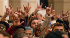 I Love You hand shapes shown during the OneLewiston Vigil at the Basilica of Saints Peter and Paul in Lewiston, Maine.  Source from David Sokol, USA Today.