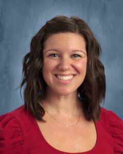 Kelli Adasko with brown hair and a red shirt