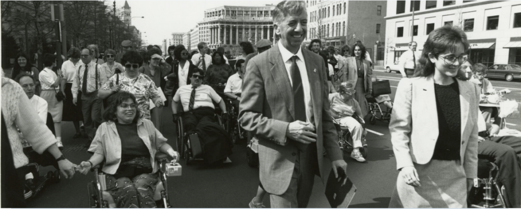 Tall man in middle in suit is Dr. I. King Jordan, Names of other 2 women on his sides for not known although familiar but names are not clear.  All are marching from Gallaudet to the US Capitol during DPN march in 1988.